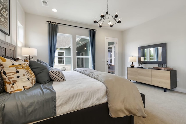 carpeted bedroom featuring a notable chandelier