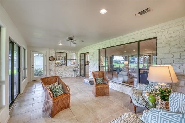 sunroom featuring ceiling fan