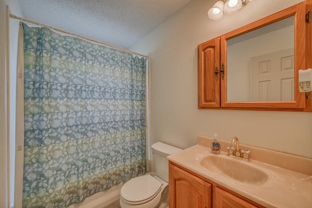 bathroom with vanity, toilet, and a textured ceiling