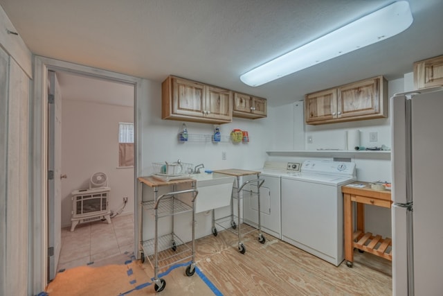 kitchen with light hardwood / wood-style floors, light brown cabinets, separate washer and dryer, and white refrigerator