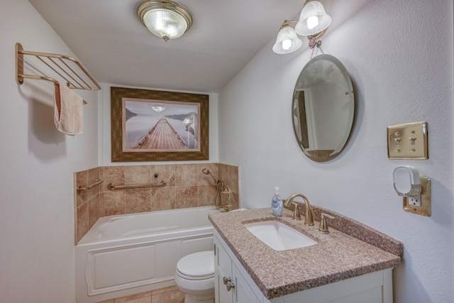 bathroom with vanity, tile patterned flooring, toilet, and a tub