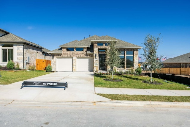 view of front of house featuring a garage and a front lawn