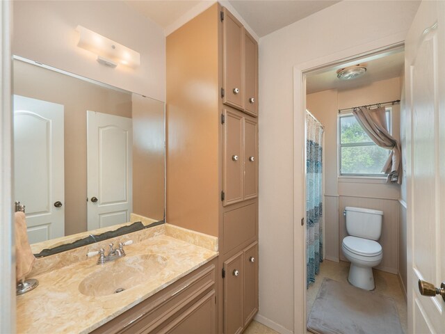 bathroom with tile patterned floors, vanity, and toilet