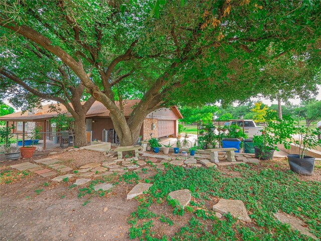 view of front facade with a garage and a patio