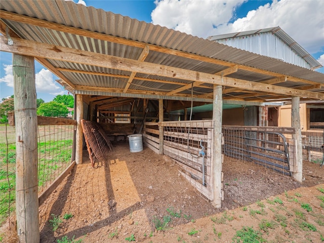 view of horse barn featuring an outbuilding