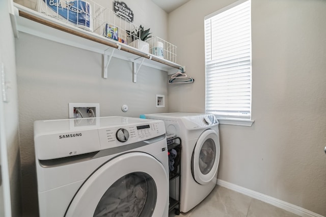 washroom featuring washer and dryer and light tile patterned floors