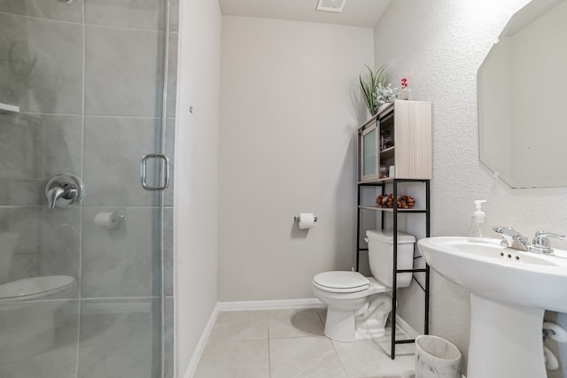 bathroom featuring toilet, tile patterned flooring, and an enclosed shower