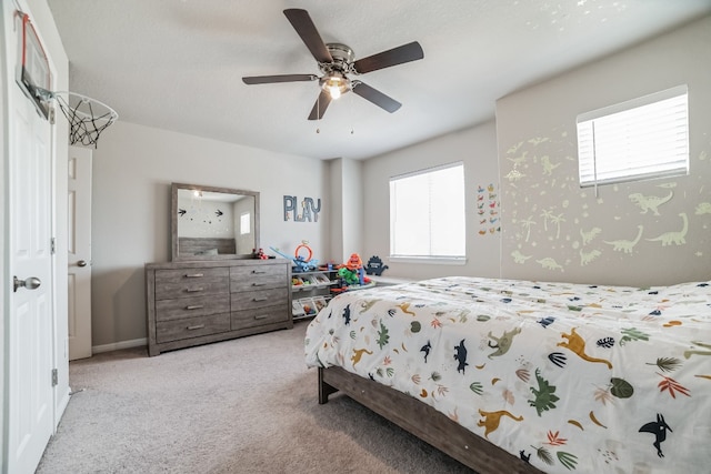 carpeted bedroom with multiple windows and ceiling fan