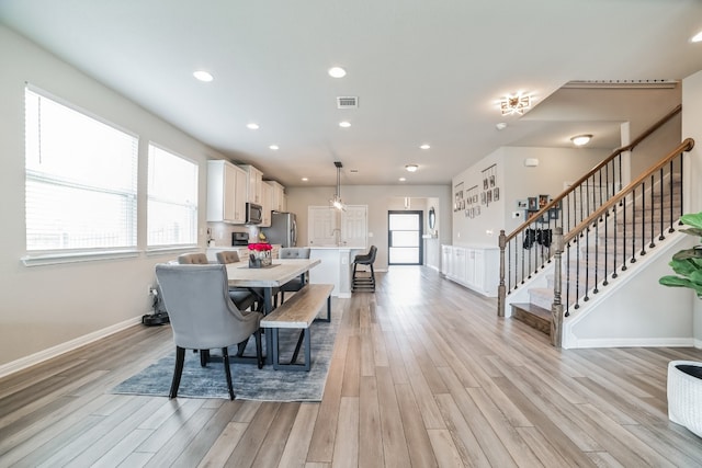 dining room with sink and light hardwood / wood-style floors