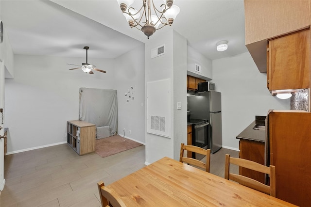 dining room featuring ceiling fan with notable chandelier and light wood-type flooring