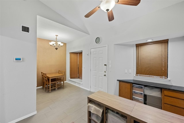 kitchen with pendant lighting, ceiling fan with notable chandelier, and lofted ceiling