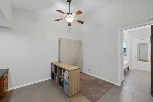 interior space with ceiling fan and vaulted ceiling