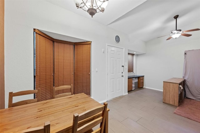 dining room with ceiling fan with notable chandelier and light hardwood / wood-style flooring