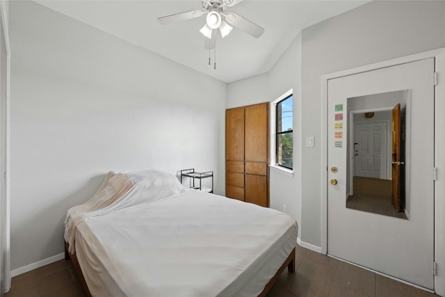 bedroom with dark hardwood / wood-style flooring and ceiling fan