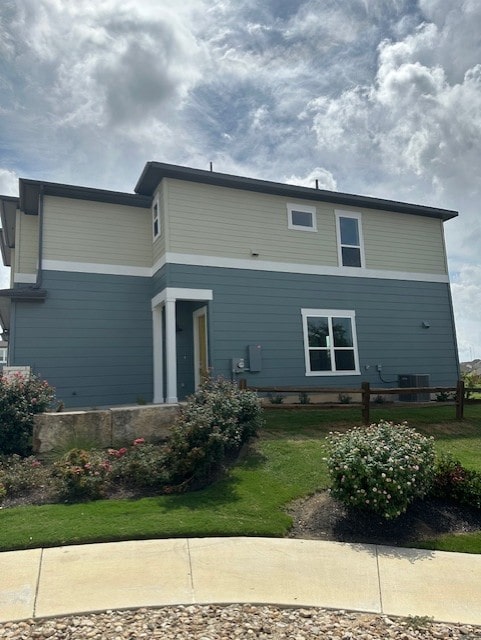 rear view of property featuring a lawn