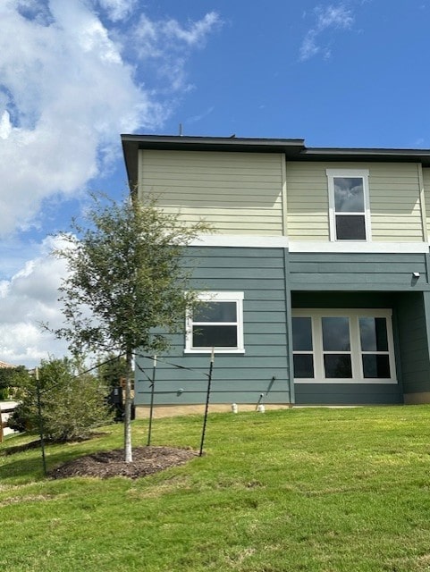 view of home's exterior with a yard