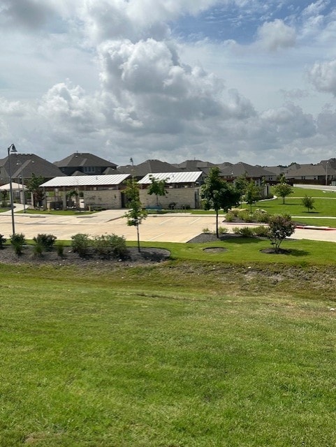 view of home's community with a lawn