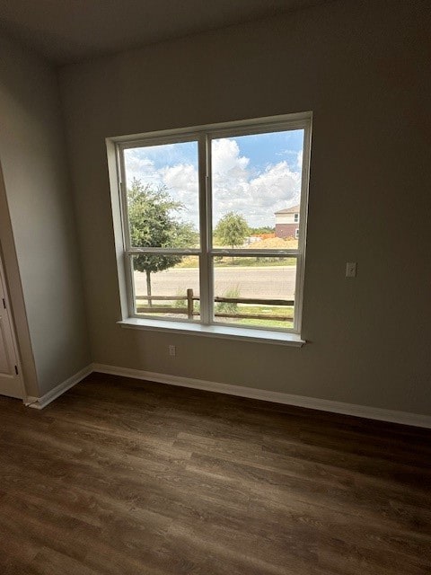 empty room with dark hardwood / wood-style floors