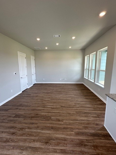 spare room with dark wood-type flooring