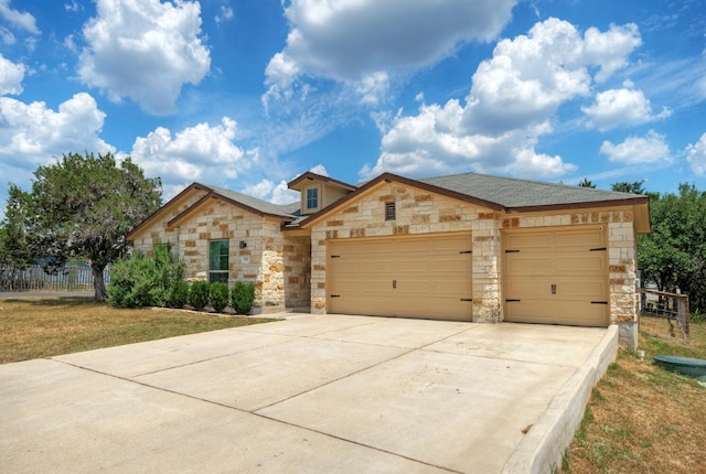 21707 Crystal Way, Lago Vista, TX 78645 - view of front of property with stone siding, an attached garage, and driveway
