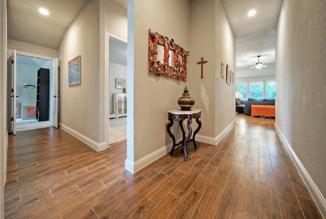 21707 Crystal Way, Lago Vista, TX 78645 - hall featuring dark wood finished floors, baseboards, a textured wall, and recessed lighting