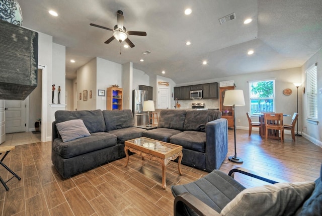 21707 Crystal Way, Lago Vista, TX 78645 - living area with lofted ceiling, light wood finished floors, ceiling fan, baseboards, and recessed lighting