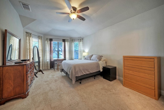 carpeted bedroom with vaulted ceiling and ceiling fan