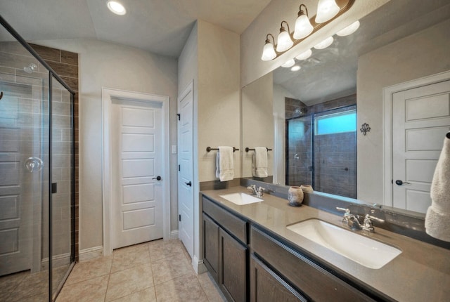 bathroom featuring tile patterned floors, a shower with door, vanity, and lofted ceiling