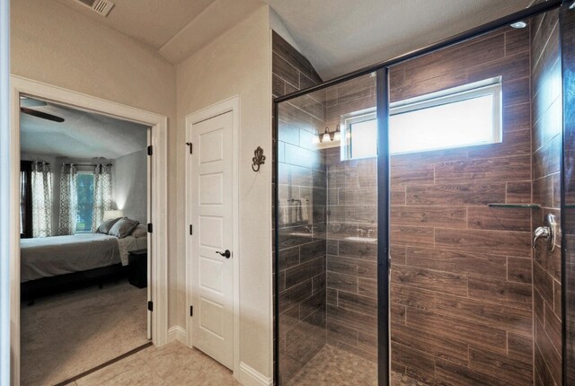 bathroom featuring a shower with door