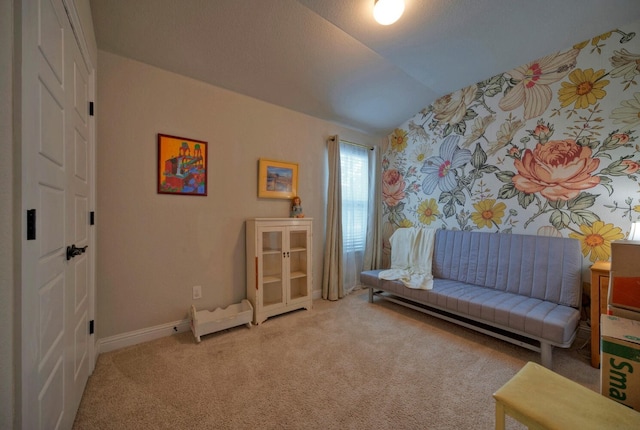 sitting room featuring carpet and vaulted ceiling