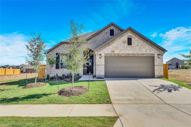 view of front of property featuring a front lawn and a garage