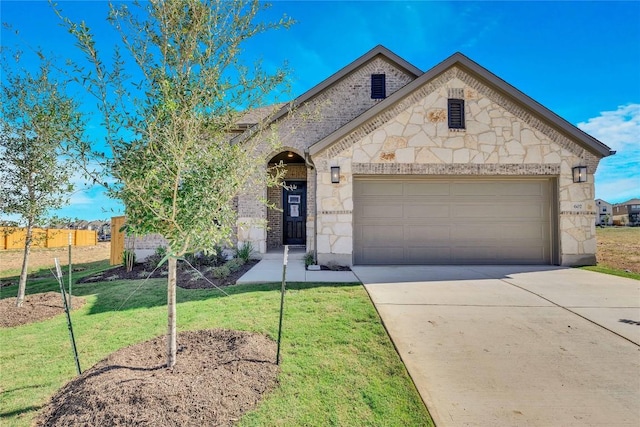 607 Breeze Hollow Ln, Georgetown, TX 78628 - view of front of home with an attached garage, concrete driveway, stone siding, a front yard, and brick siding