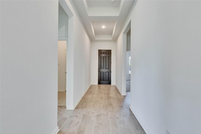 607 Breeze Hollow Ln, Georgetown, TX 78628 - corridor featuring a tray ceiling and light wood finished floors