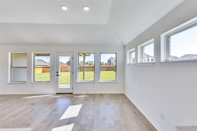 empty room featuring light hardwood / wood-style floors and lofted ceiling