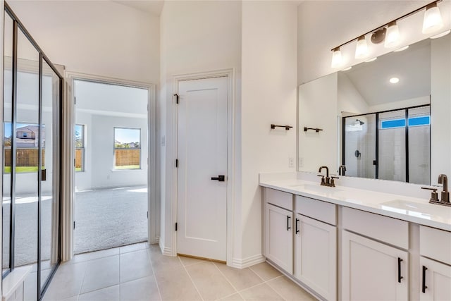 bathroom featuring tile patterned floors, vanity, a shower with shower door, and vaulted ceiling