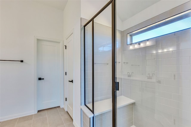 bathroom with tile patterned flooring and walk in shower