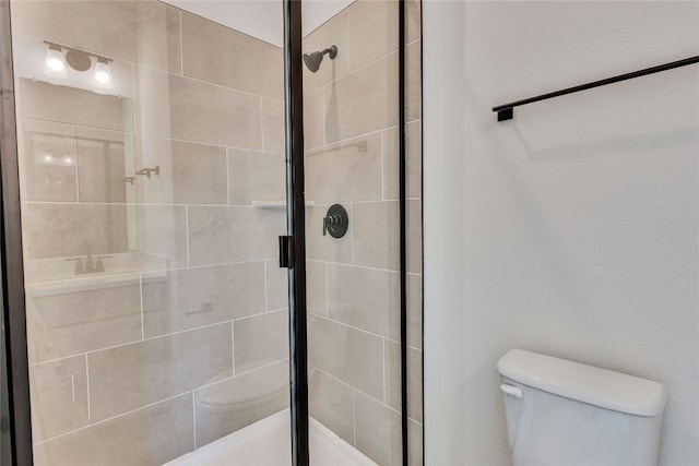 bathroom with a shower with door and toilet