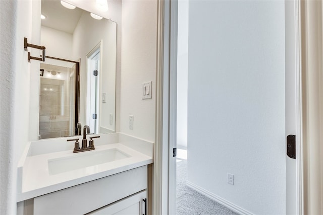 bathroom featuring vanity and tiled shower