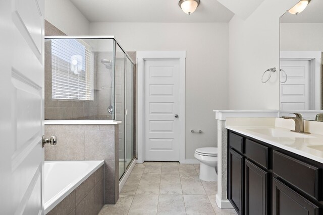 full bathroom with tile patterned flooring, shower with separate bathtub, toilet, and vanity