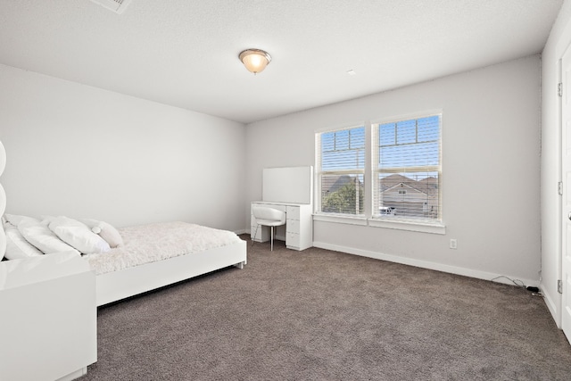 unfurnished bedroom with dark colored carpet