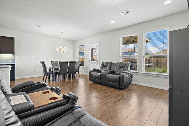 living room featuring a chandelier and hardwood / wood-style flooring