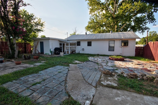 back of property with a patio