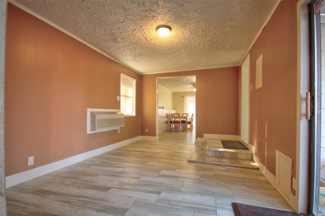 unfurnished room with ornamental molding, a wall unit AC, and wood walls