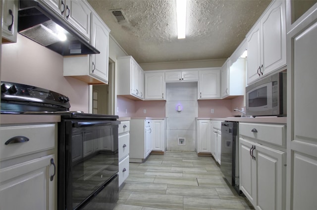 kitchen with a textured ceiling, black appliances, and white cabinets