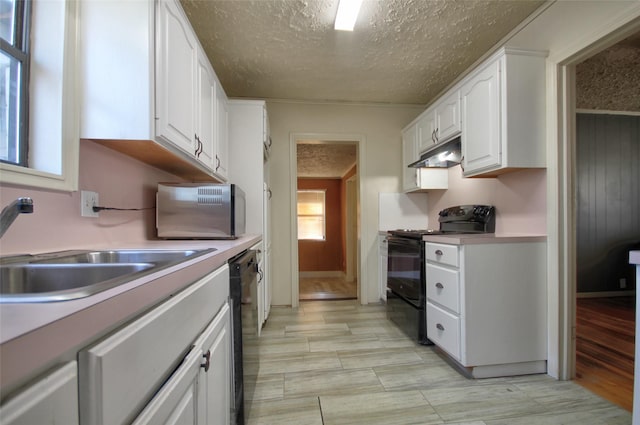 kitchen featuring white cabinetry, sink, black appliances, and a textured ceiling