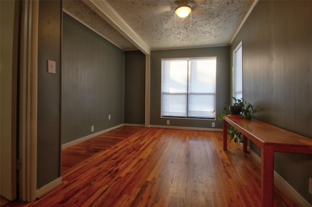 interior space featuring dark wood-type flooring and ornamental molding