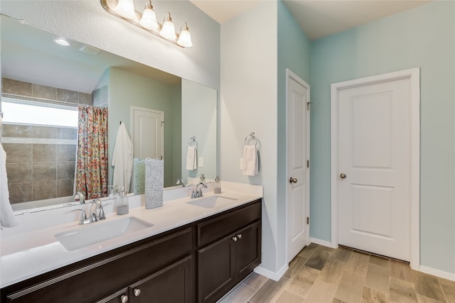 bathroom with vanity, wood-type flooring, and shower / bath combo