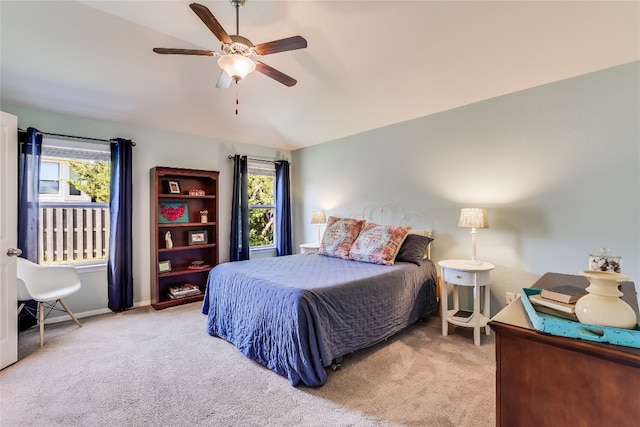 carpeted bedroom featuring multiple windows and ceiling fan