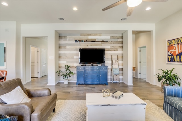 living room with light hardwood / wood-style flooring and ceiling fan