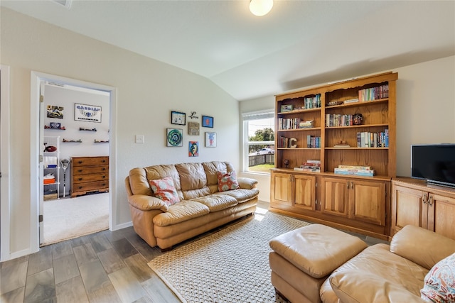 living room with hardwood / wood-style floors and vaulted ceiling